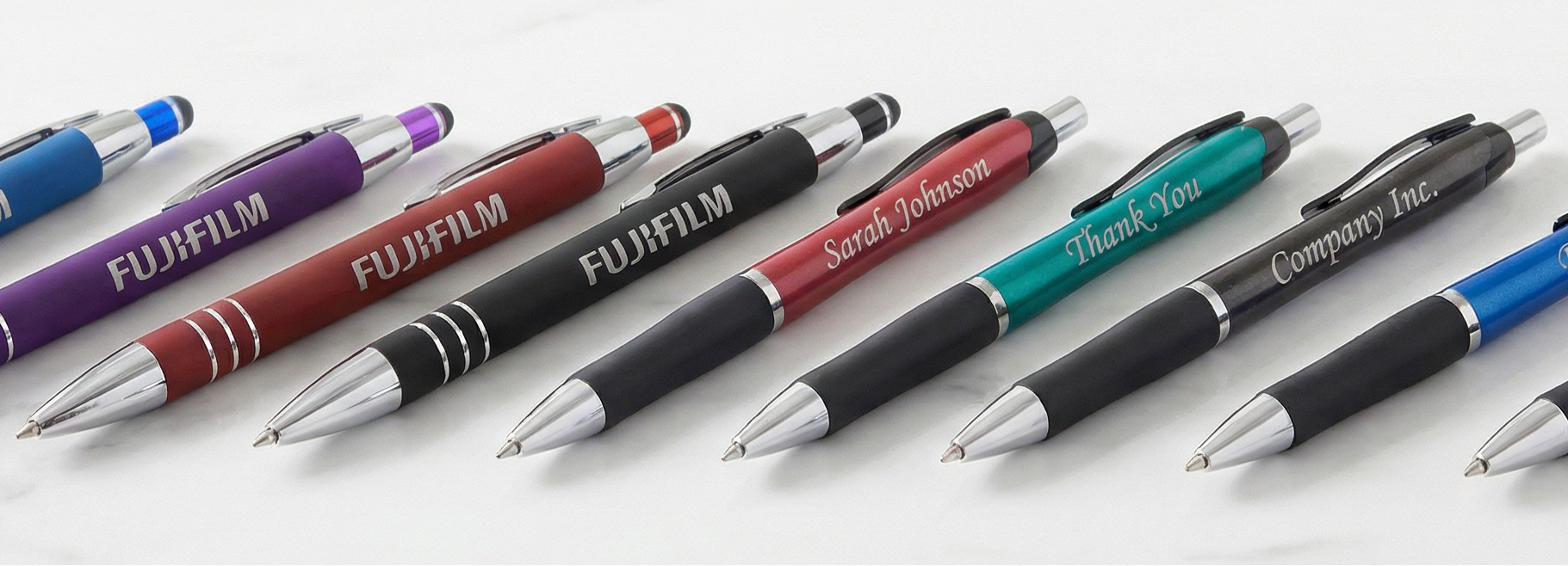 Promotional image of personalized pens with various colors and a visible brand logo on a white background.