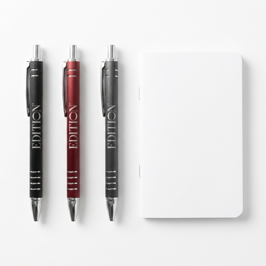 Three pens with 'EDITION' branding and a small notebook on a white background