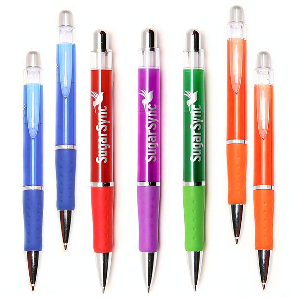 Seven colorful Translucent Xpress Odyssey pens by PensXpress, with red grips and "SugarSync" custom printing, stand upright on a white background. The barrels are blue, purple, green, and orange with silver clips and clear push buttons.